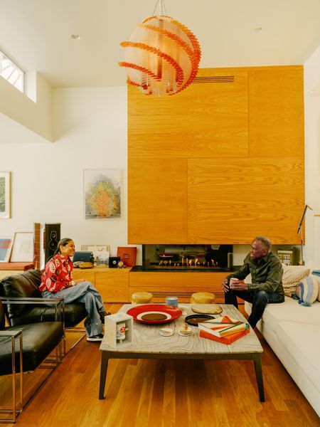 A pendant light by Jorge Pardo hangs above the living room (opposite), while one of Charles’s pieces hangs next to the fireplace.