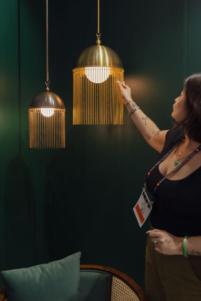 At the Javits Center in New York, pendants by Indo, a Rhode Island studio, featured brass domes with strings of beads.