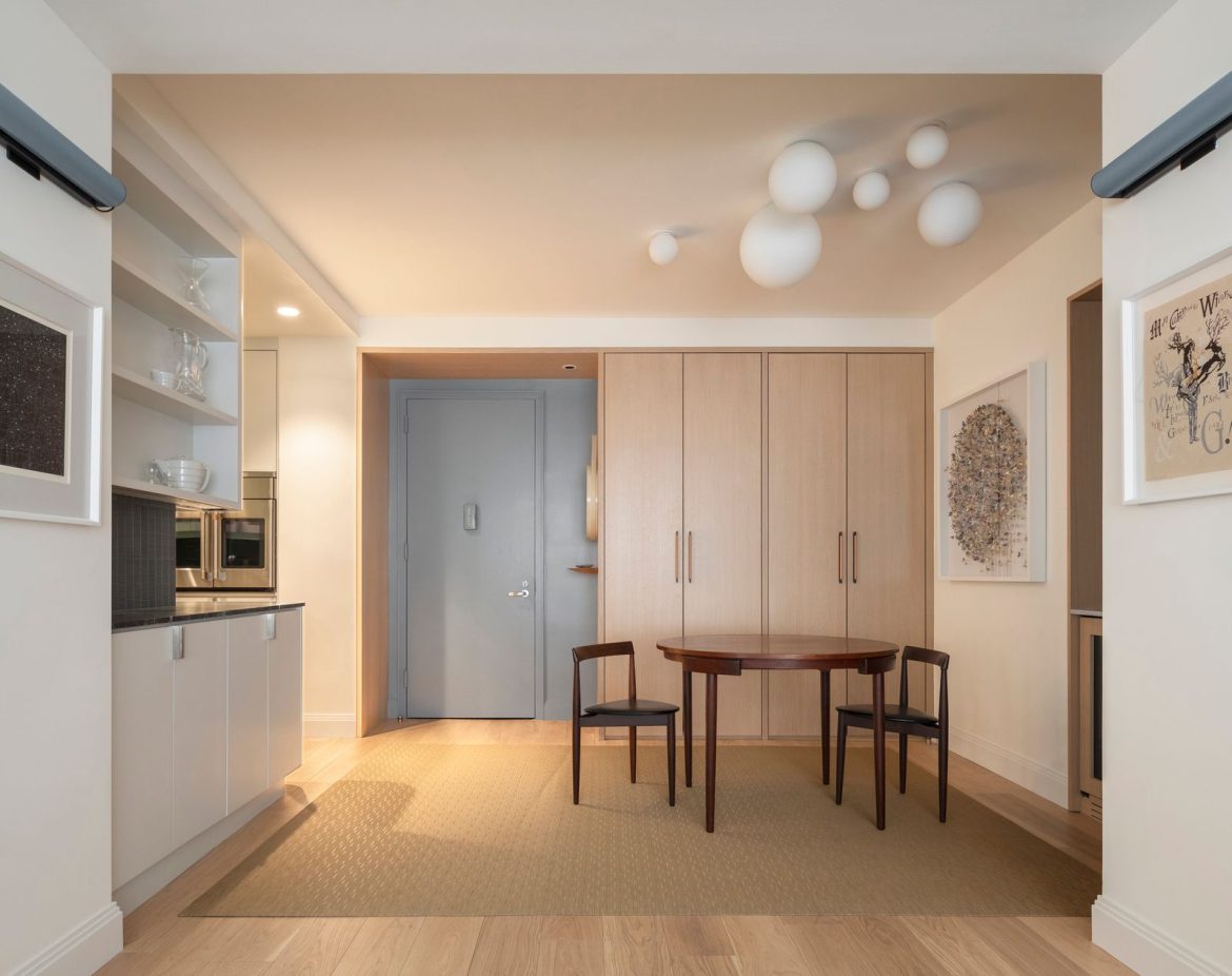 dunham-robinson-transformed-a-couples-new-apartment-with-a-warm-entry-sequence-defined-by-an-oak-storage-piece-in-the-foyer.jpg