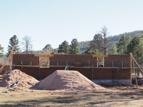 Scaffolding is added to the structure as it’s built up to provide support while it dries.
